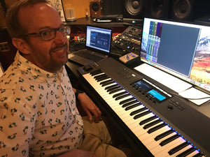 Steinway Artist and composer Kevin Kern sitting at the keyboards in the recording studio.