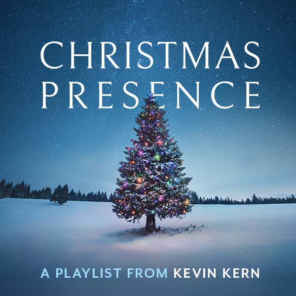 Outdoor lighted Christmas tree in a snow covered field, titled "Christmas Presence - a playlist from Kevin Kern", a Spotify playlist