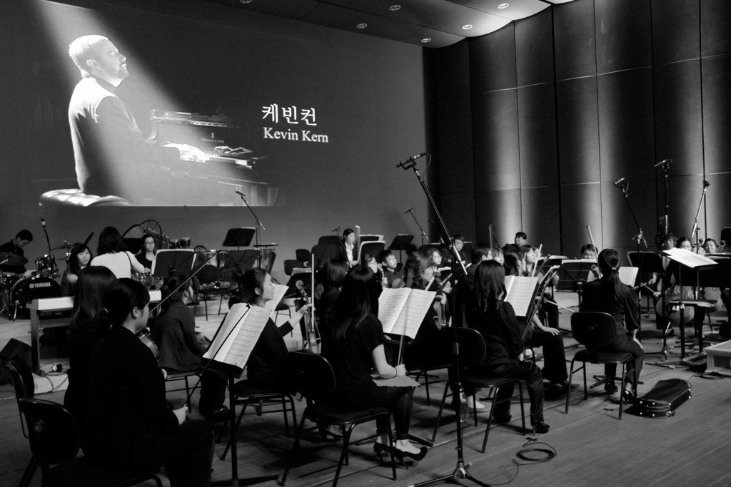black and white photograph of orchestra during rehearsal for Kevin Kern concert